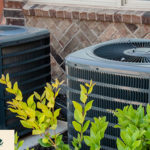 HVAC units hidden behind bushes.