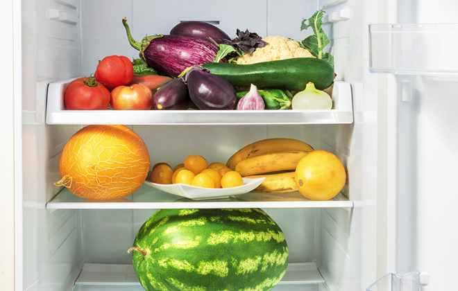 Shelfs in the refrigerator with vegetables.