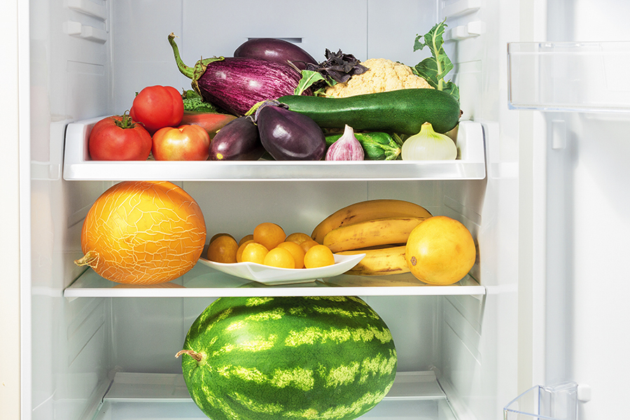 Shelfs in the refrigerator with vegetables.