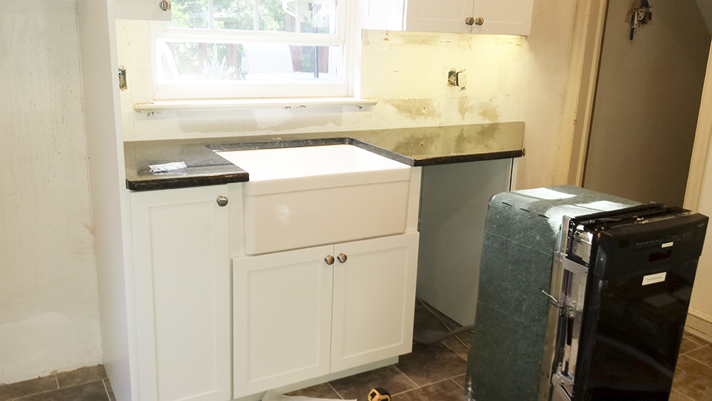 A rew dishwasher being installed.