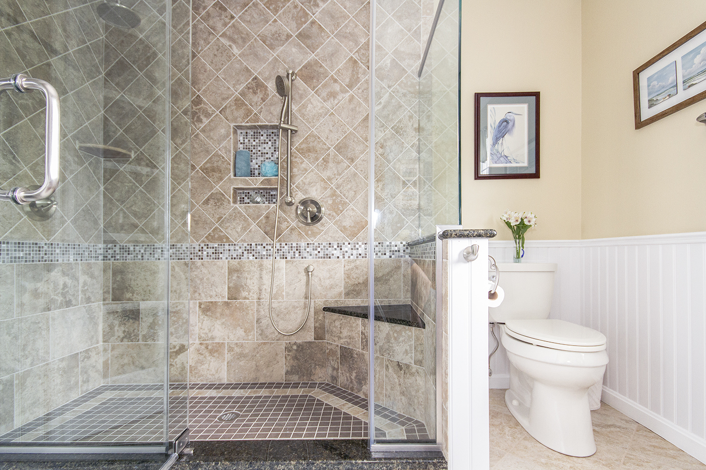 A tiled shower with a glass door.