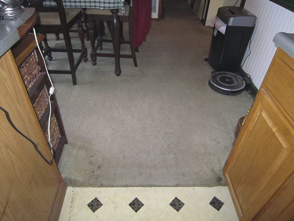 A carpeted dining room.