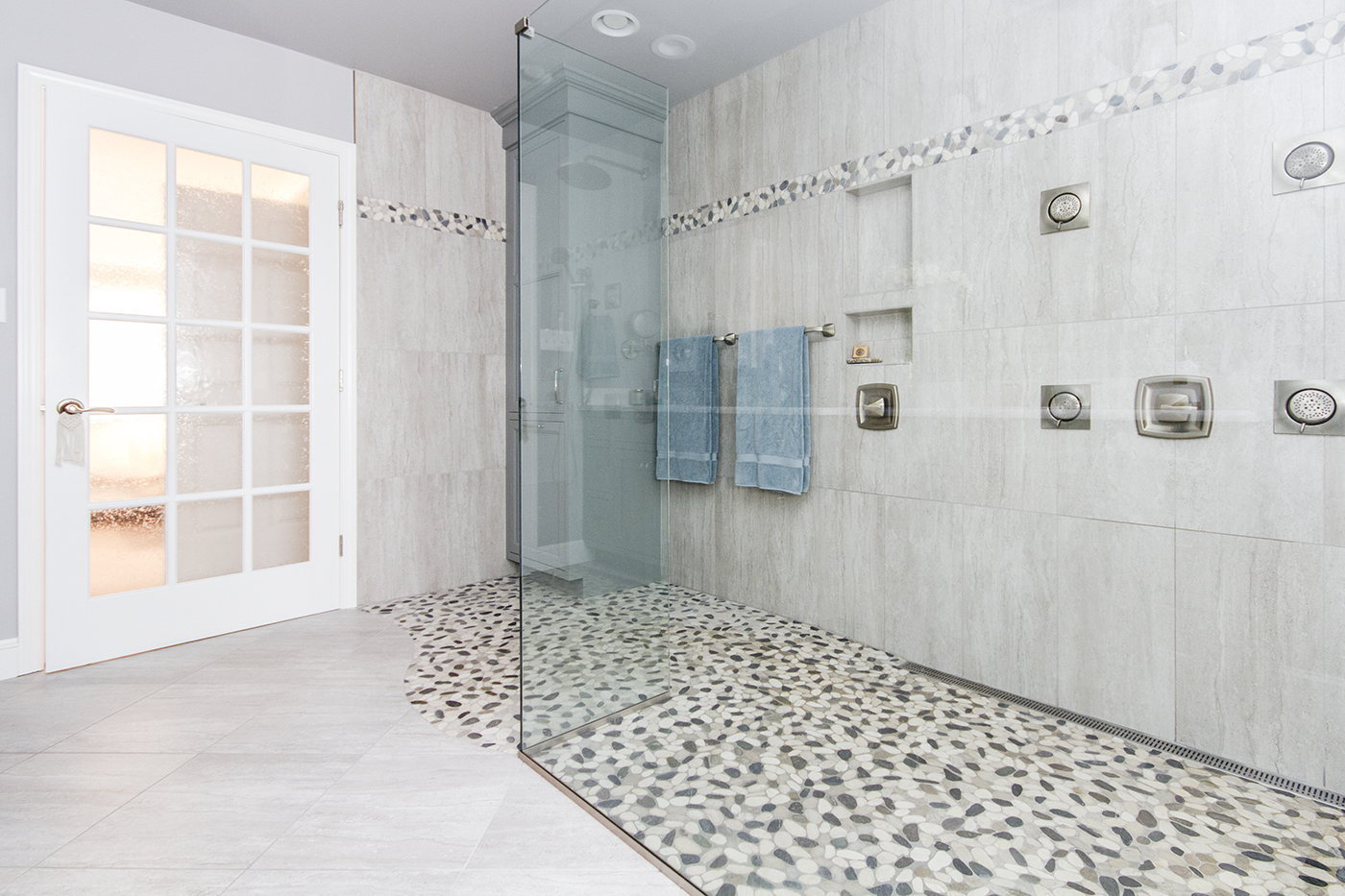A glass enclosed shower.