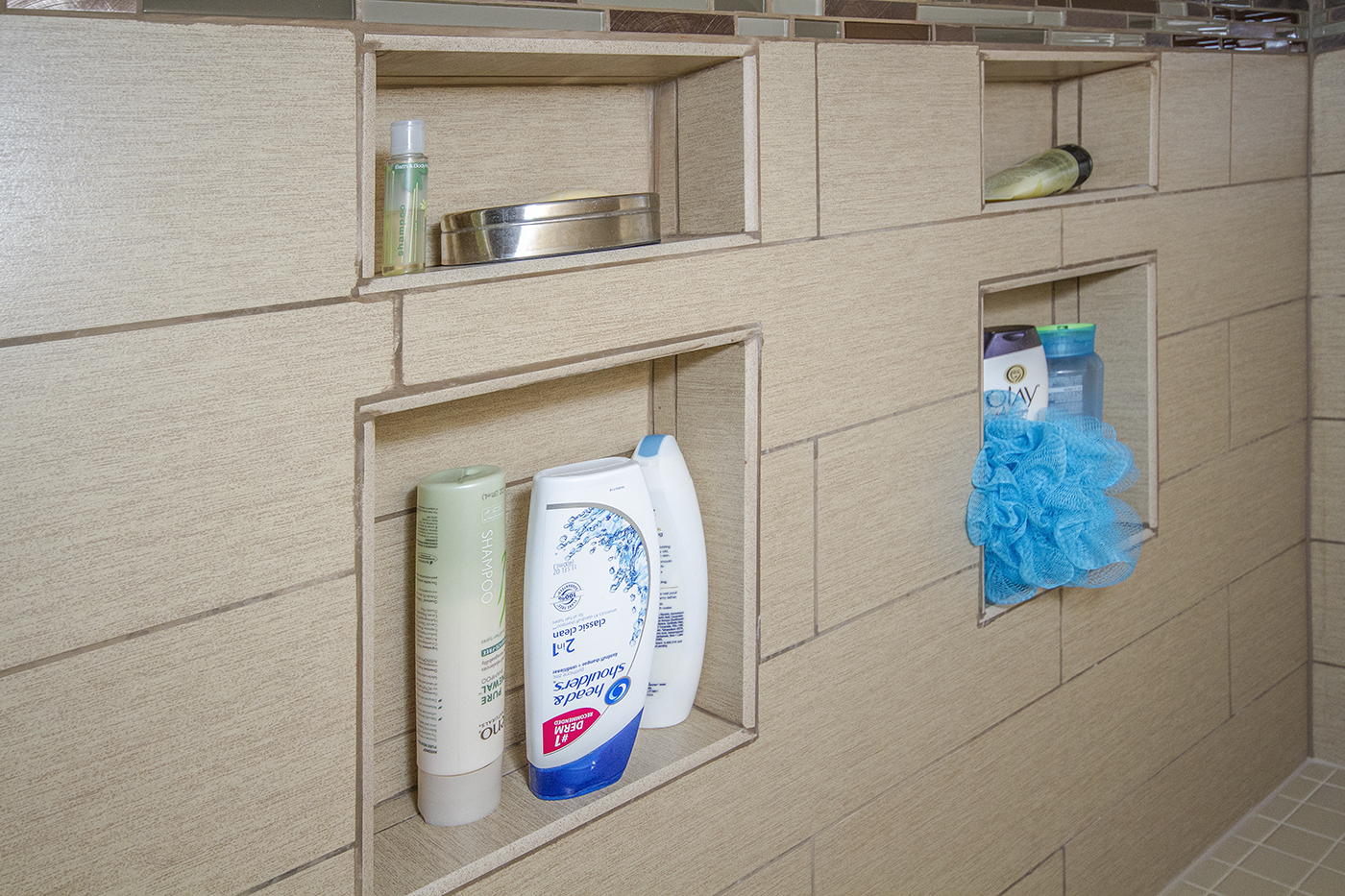 Shelves built into a shower wall to hold soap and shampoo.