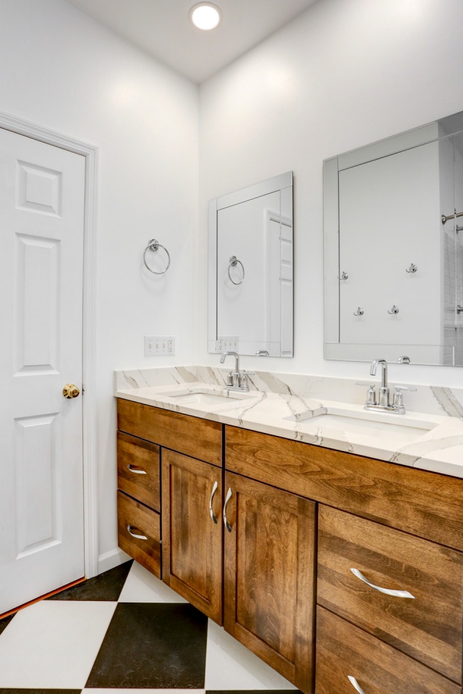 jack and jill bathroom sink with wood cabinets
