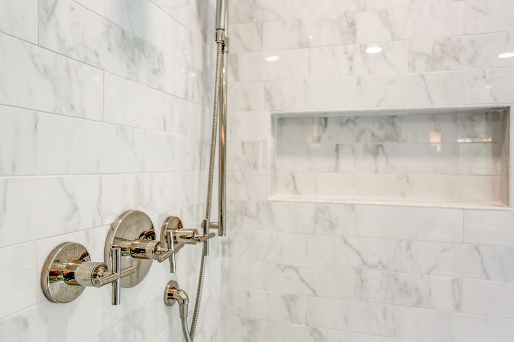 shower faucet with recessed shampoo nook in wall