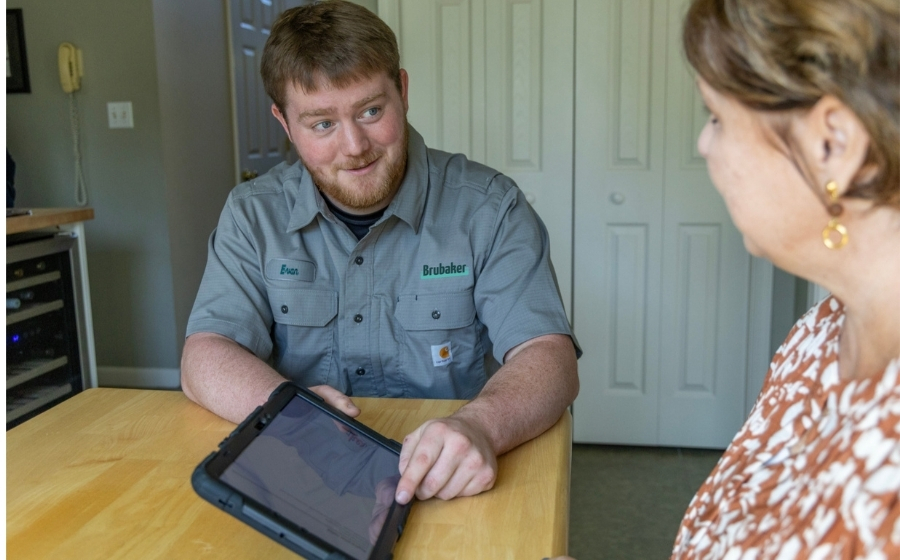 residential plumber reviewing customer's service options, Lancaster PA